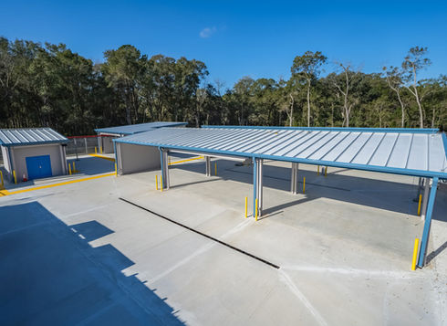 Aerial view of covered hazardous waste handling bays with red piping