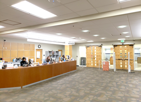 Staff at a university library lobby circulation desk