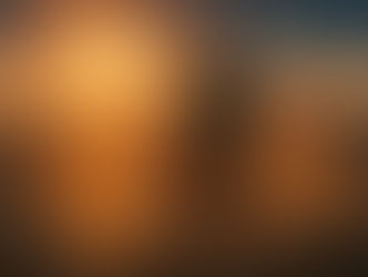 Woman with outstretched arms stands on a rocky ledge at sunset, surrounded by swirling golden light patterns. Serene and joyful mood.