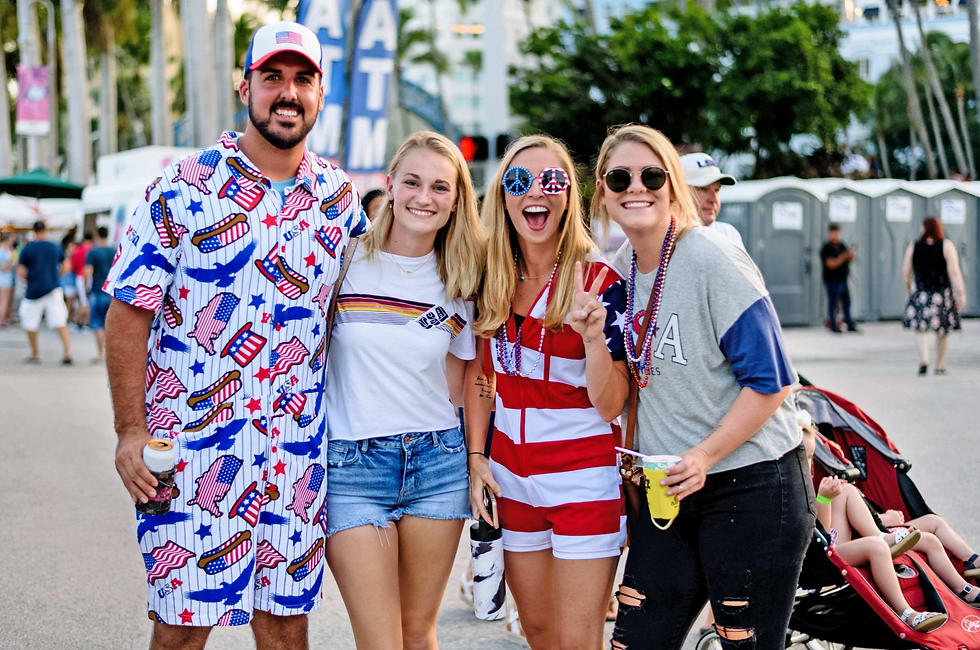 Friends show off their patriotic spirit during last year's Fourth on Flagler celebration along the West Palm Beach waterfront. [Photo by the City of West Palm Beach]