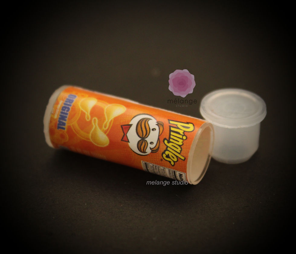 Thumbnail: Miniature resin Pringles cans in orange, green and red variants for dollhouse and diorama displays