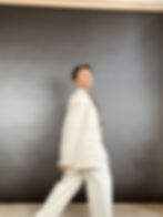 A girl walking in a beige suit 