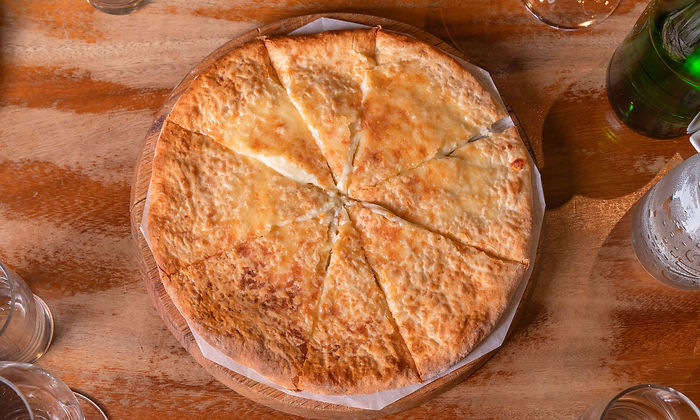 Khachapuri Imeruli, round Georgian cheese bread, cut into wedges