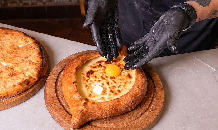 Egg going into a Khachapuri Adjaruli at Bevri