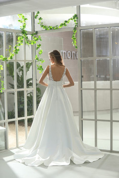 Elegant bridal gown with supportive lace straps, flowing silk skirt, and back buttons.
