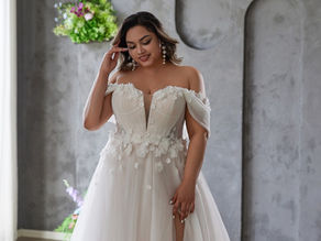 Romantic off-the-shoulder wedding dress with floral appliqué