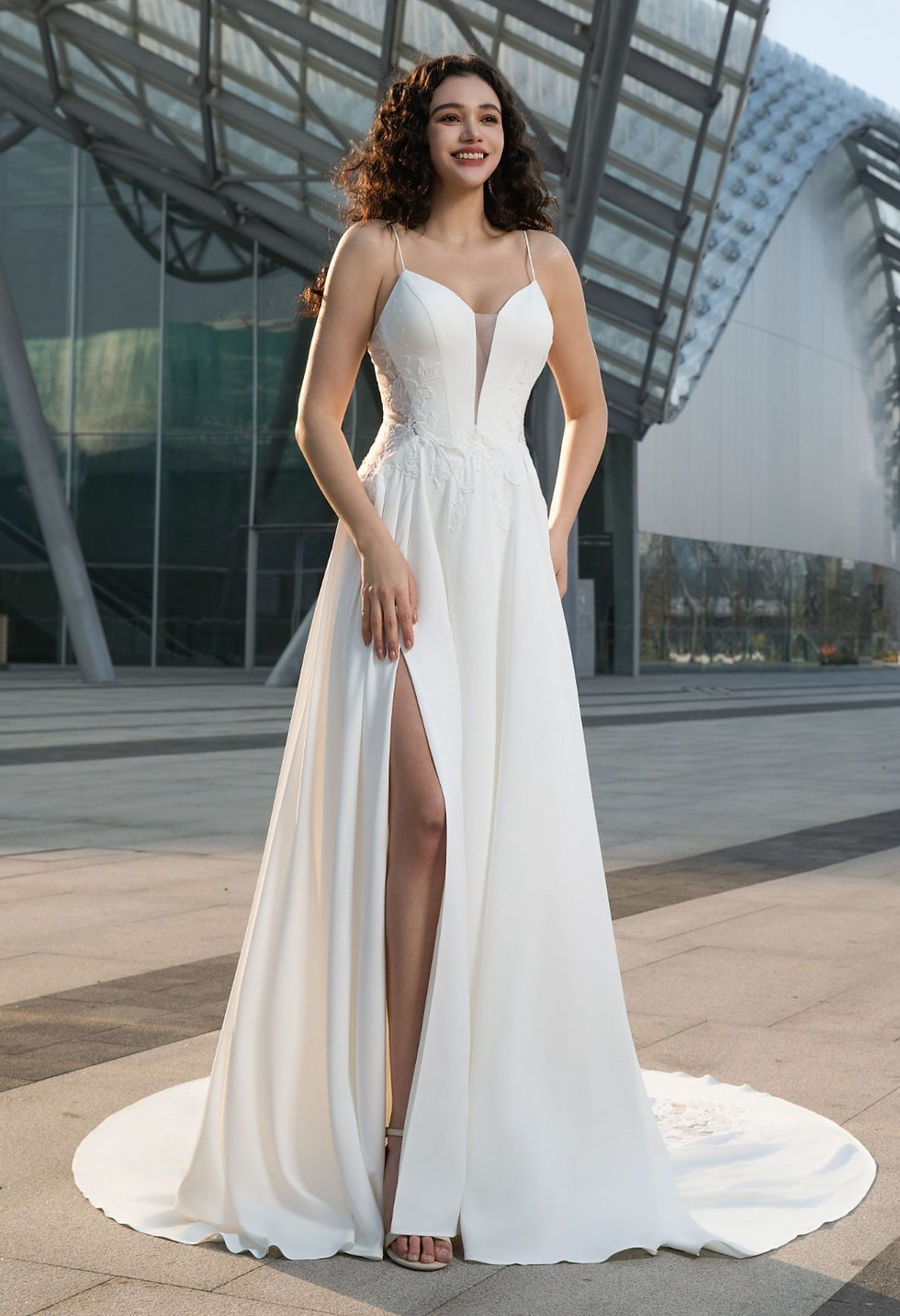 Elegant lace wedding dress with flowing skirt and slit