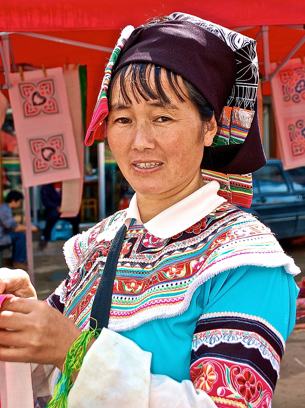 Yi woman embroidering at market