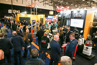 an exhibition stand - bright colours, lots of people