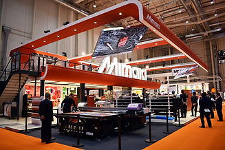 an exhibition stand - bright colours, lots of people