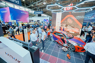 an exhibition stand - bright colours, lots of people