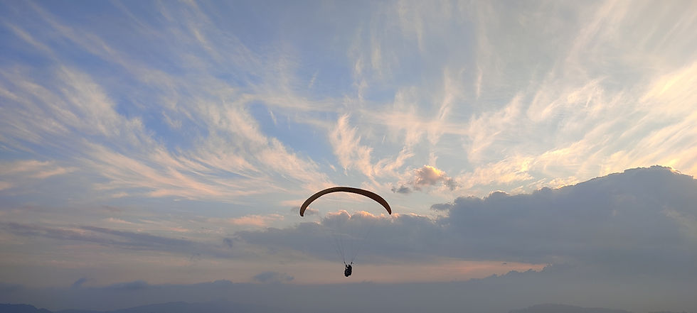 Beaitul sunset with paragliders in the sky. Picture aken by pilot Novel from Delo hill paragliding take off point.