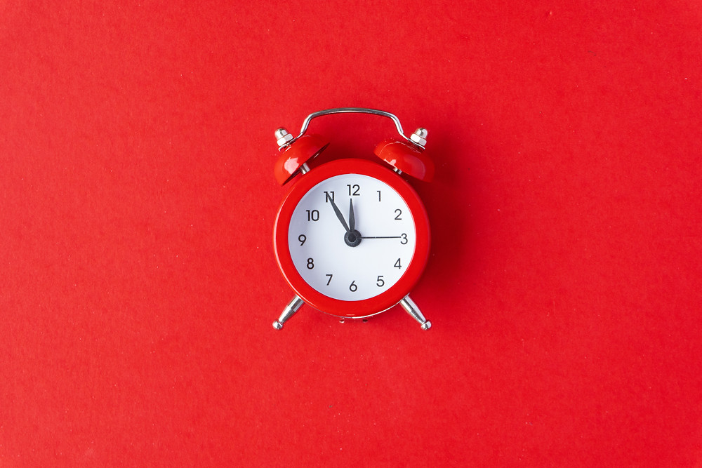 A clock showing that a woman's period is late.