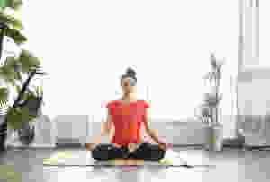Woman doing yoga to help her period cramps
