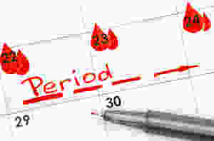 Someone writing down what day they are getting their period.