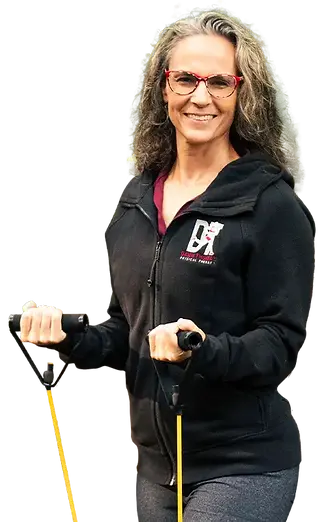 woman smiling with exercise bands in hands