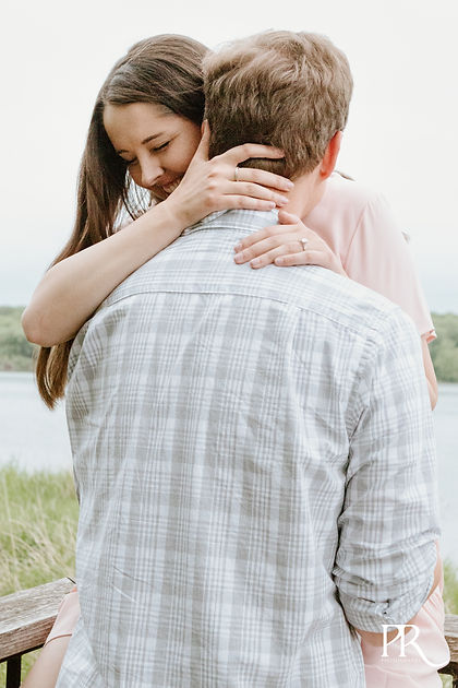 couple hugging for Engagment photos in minneapolis minnesota