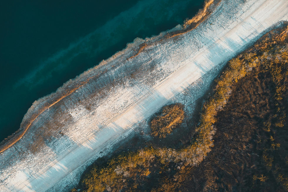 Aerial view of a road beside a lake and forest. Perspektiv Australia.