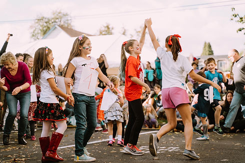 Young girls dance together on the street during the Polish Festival