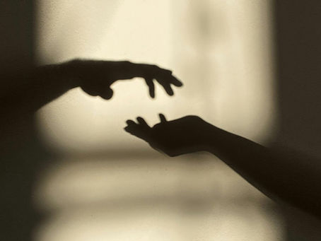 What is a Spirit Communication deck? two human hands reaching for one another.