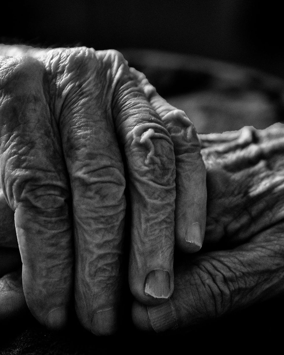 Release Ceremony: Two elder people holding hands