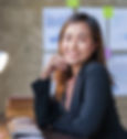 Beautiful Asian businesswoman sitting and smiling at the camera at work happily in the off