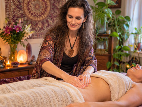 Woman receiving gentle belly massage during a holistic bodywork session with Asttarte Deva in Philadelphia
