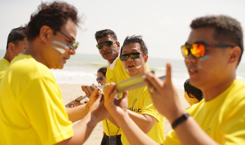 Team navigating a field-based bonding activity in JB.