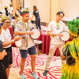 Corporate staff drumming together during music team building retreat in Desaru westin