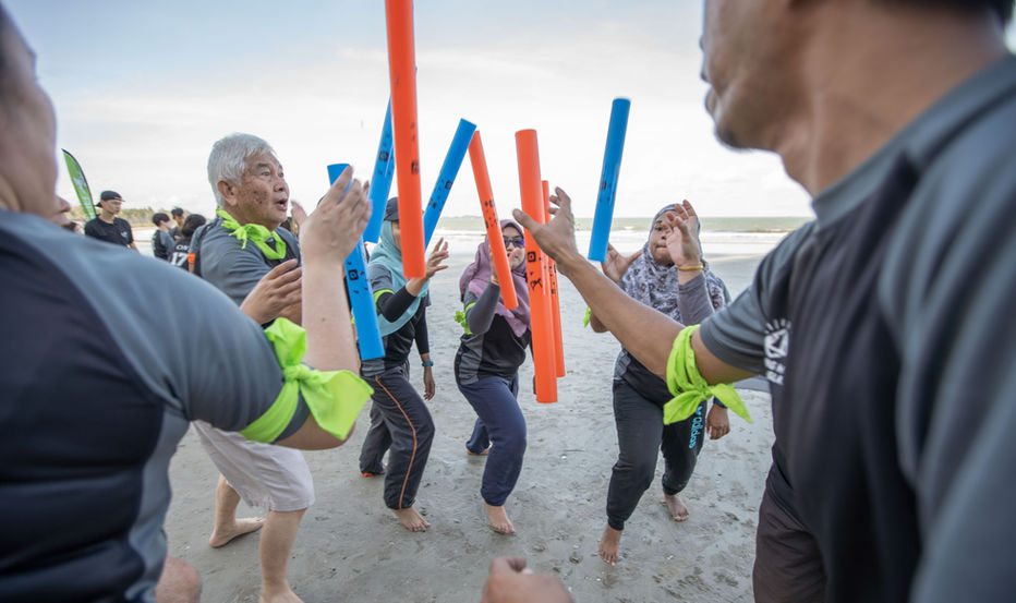 Coastal mission-style team building activity on Desaru beach.