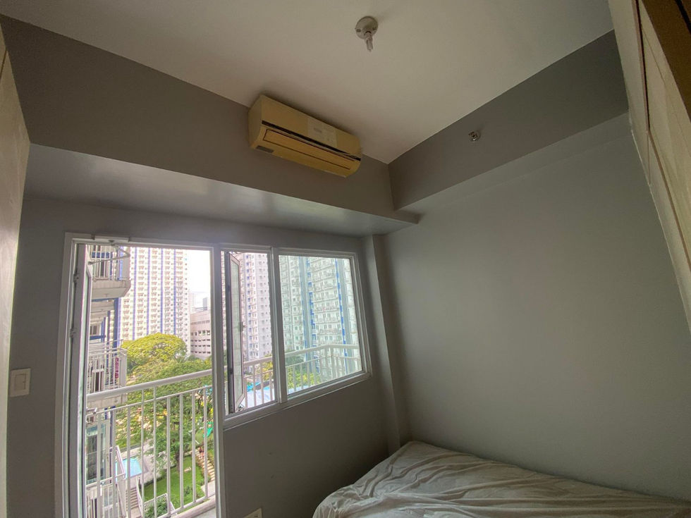 Bedroom with air conditioning and city balcony view