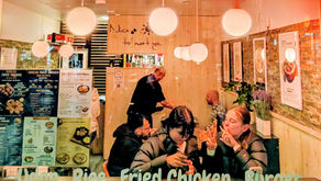 A picture of the restaurant looking through its window