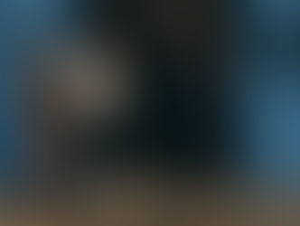 The four owners standing at the entrance. With blue industrial doors and a cobbled street