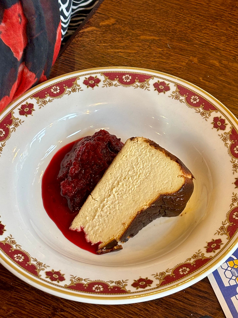 A thick wedge of Basque Cheesecake with scarlet berry compote