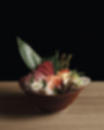 A bowl of various types of sashimi and sushi