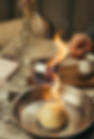 A baked Alaska being flambe'd at the table