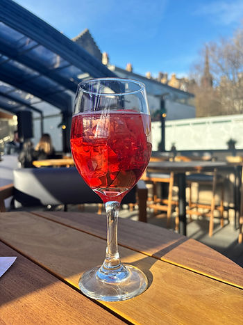 A campari spritz against the background of a blue sky