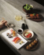 Various shaped plates of various sushi dishes, chopsticks and wine