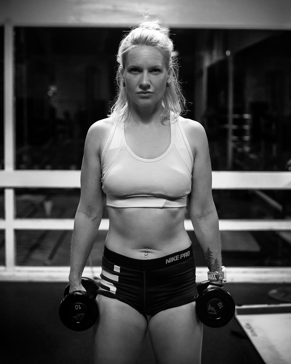Eye-level view of a woman lifting weights in a gym