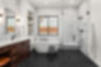 Beautiful bathroom in luxury home with double vanity, bathtub, and shower. Features herrin
