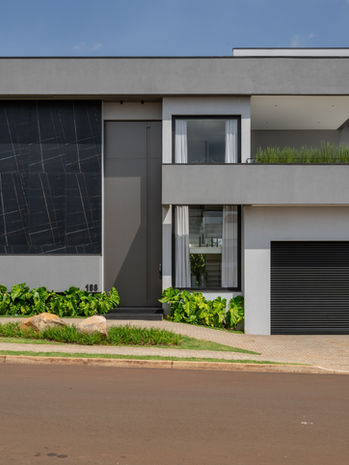 Fachada de casa moderna com garagem e design contemporâneo.