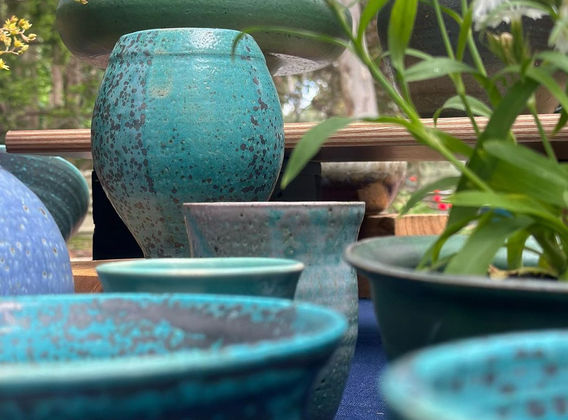 Selection of ceramic bowls and vases in turquoise glaze