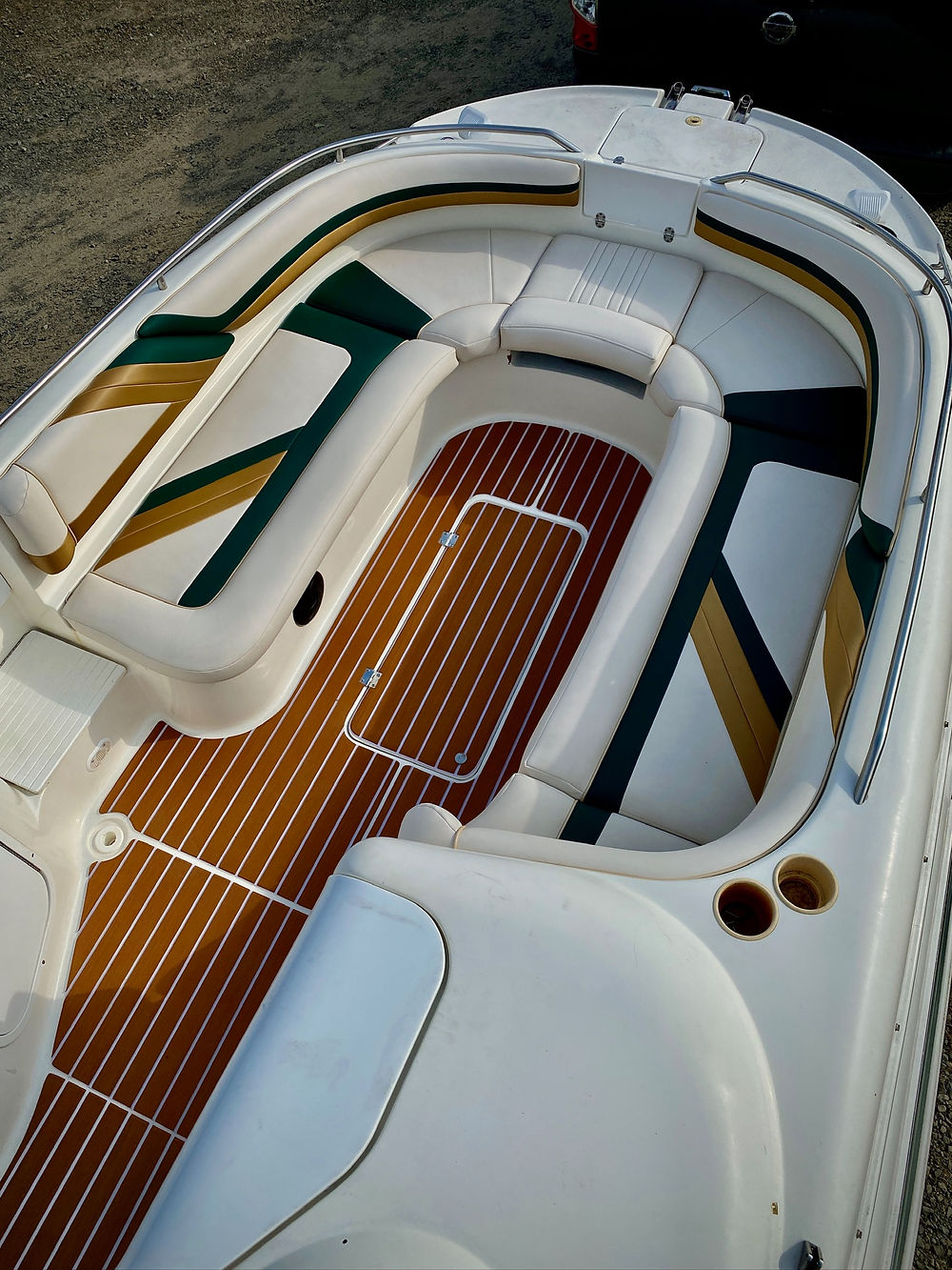 Marine boat cockpit, wood deck, striped seats
