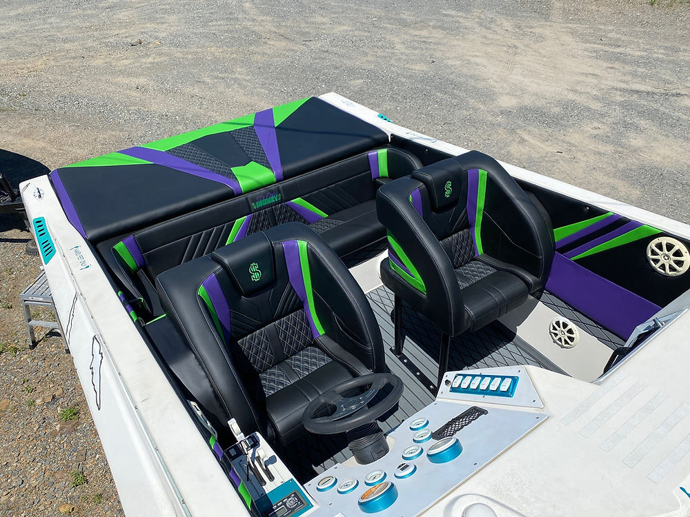 Marine boat interior with black, green, and purple seats