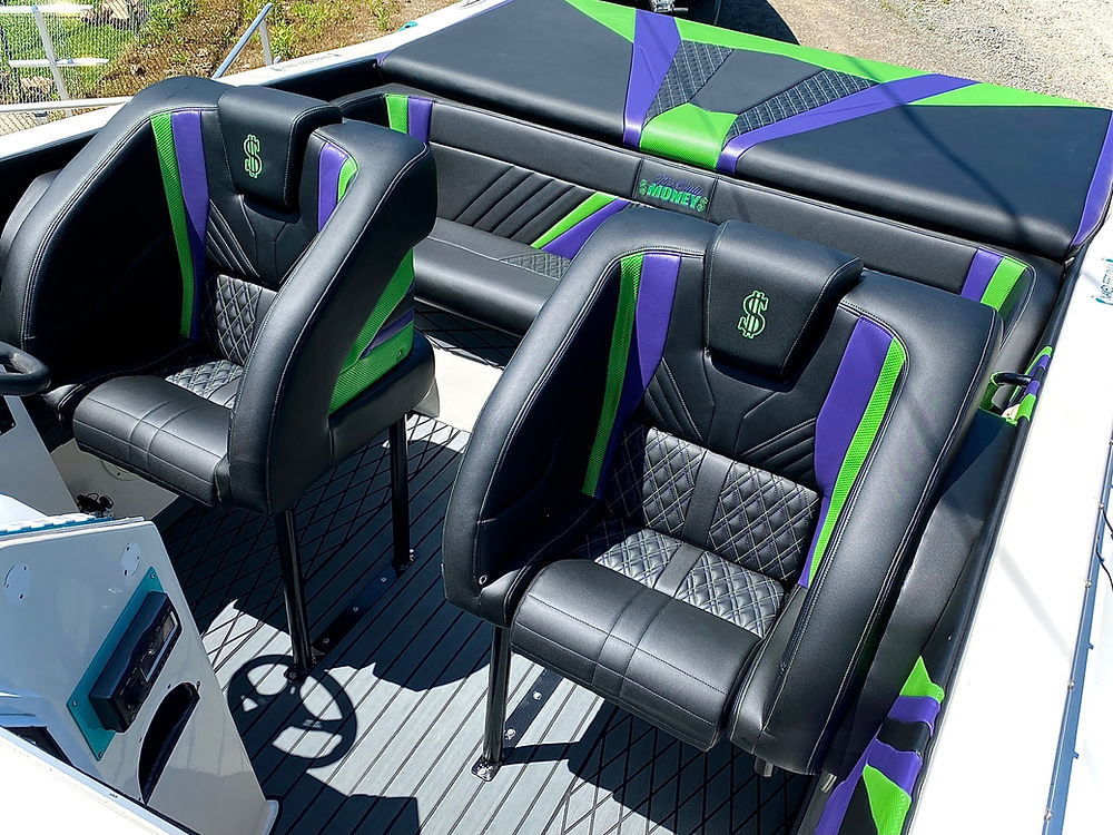 Marine boat interior with black, green, and purple seats.