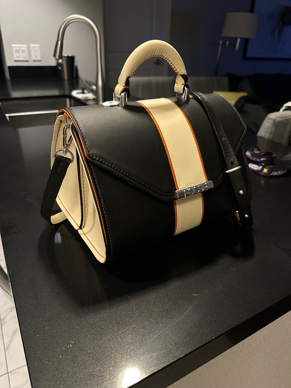 Black and cream bespoke leather bag with orange stripe