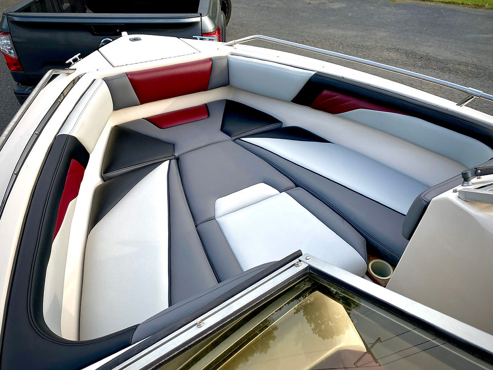 Marine boat bow seating with red, white, gray upholstery