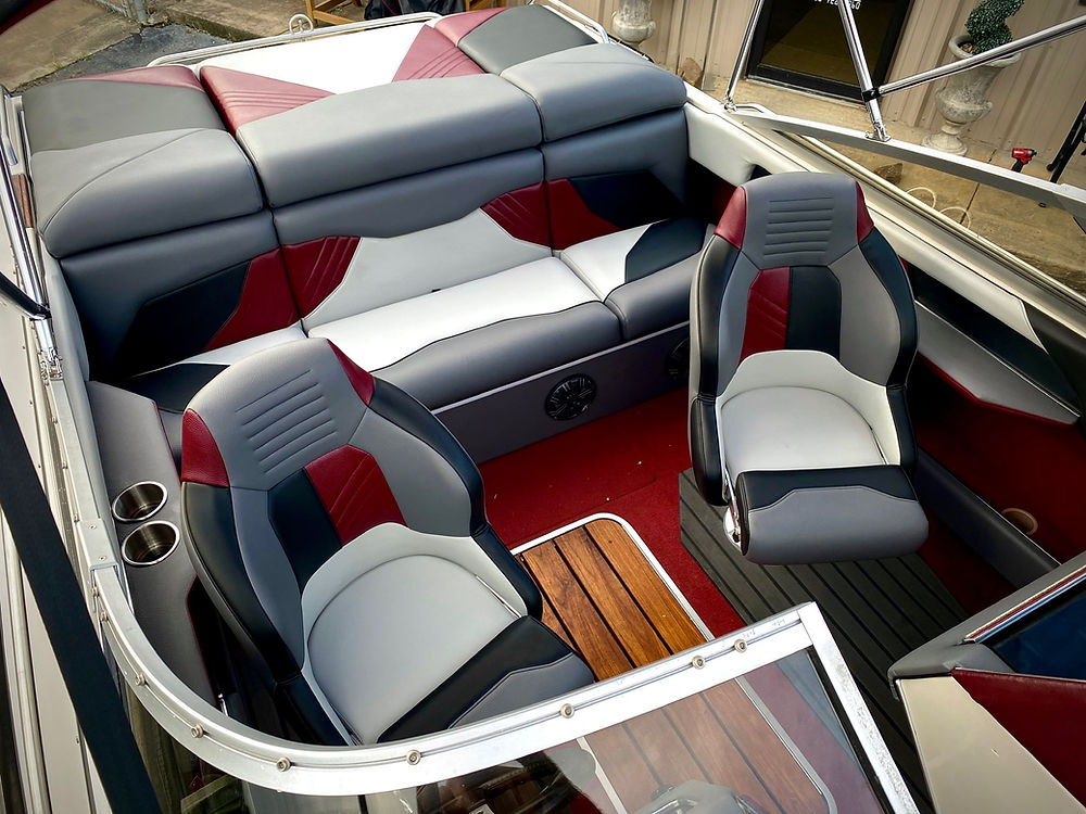 Stylish marine boat interior with red and grey seating.