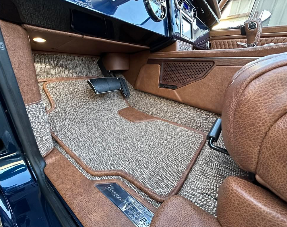 Custom floor mats and leather interior of a 1977 Bronco
