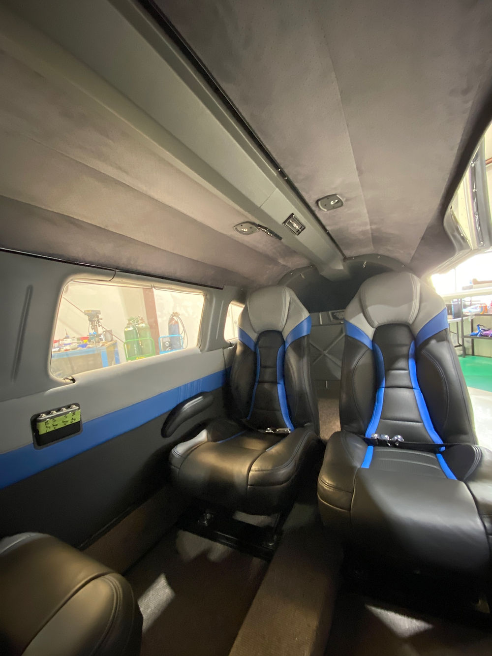 Interior of an aircraft cabin with black and blue seats
